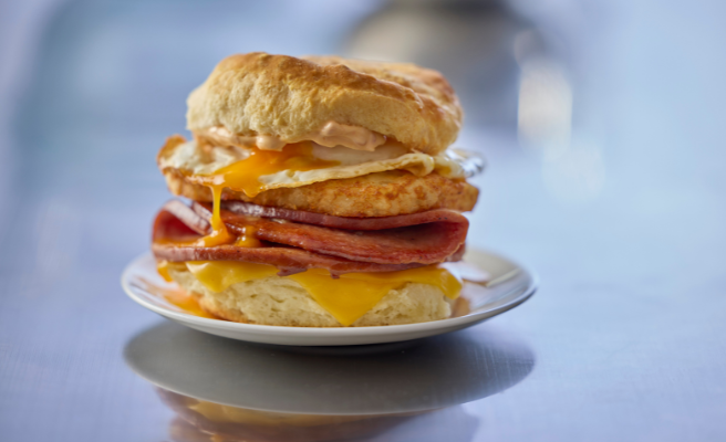 Fried Mortadella sandwich sitting on a small, white plate.