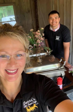 Melissa, owner of Donna’s Old Town Cafe in front of her buffet with staff