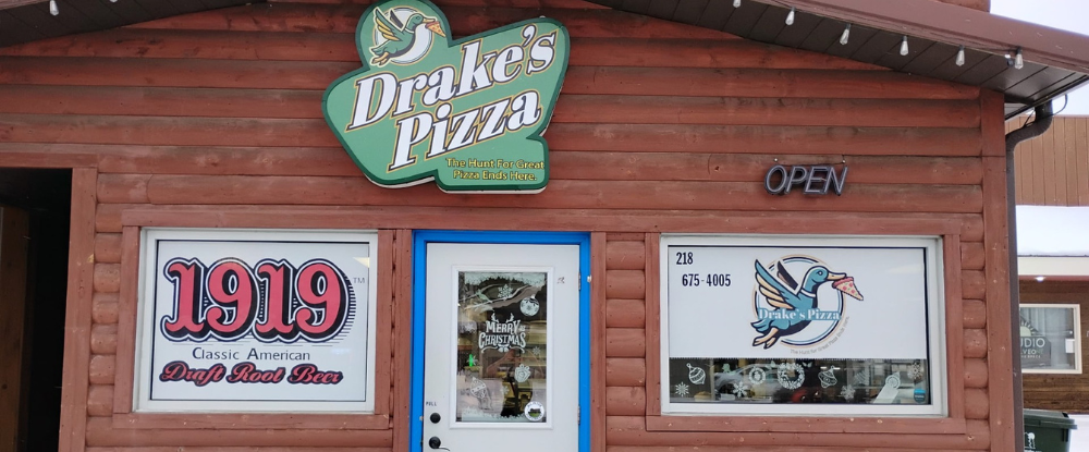 Restaurant owner Rob Walton smiles inside Drake’s Pizza, representing a veteran-founded, community-driven pizzeria brand in northern Minnesota