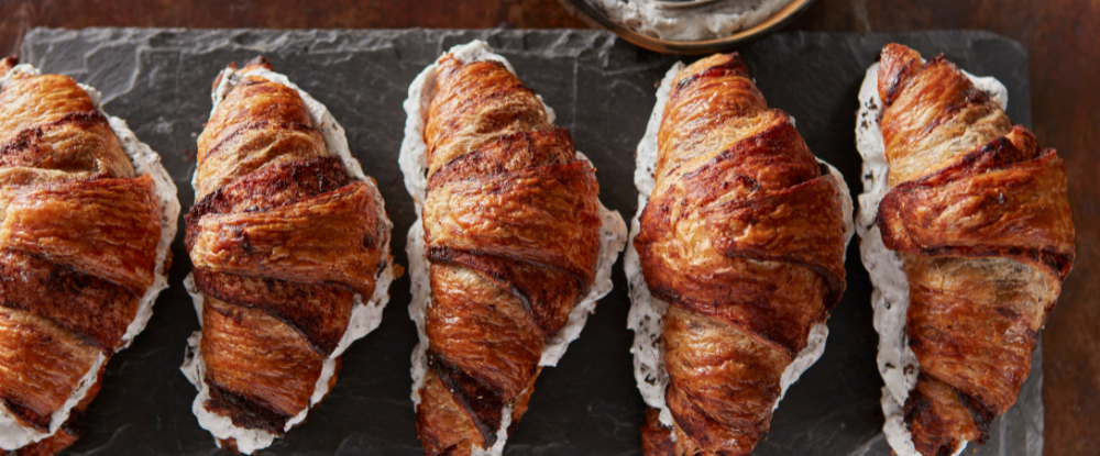 Five baked chocolate croissants.