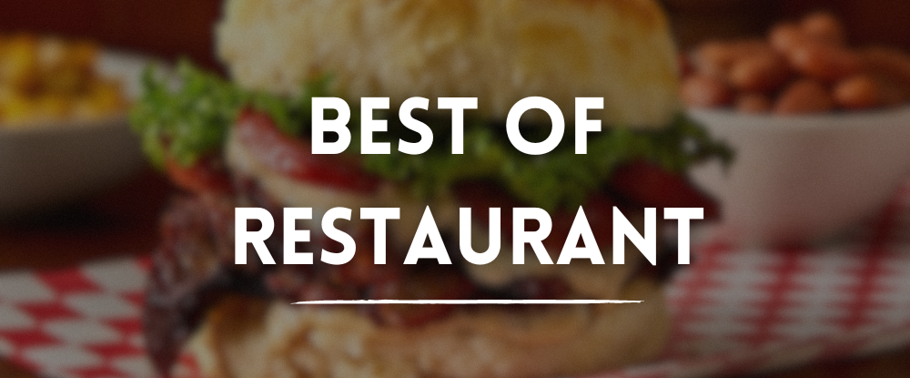 Blurred biscuit sandwich on red and white gingham surface with a side of baked beans and white text “Best Of Restaurant” overlay