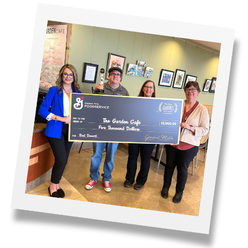 Group of people holding large black check for $5,000 from General Mills Foodservice made out to The Garden Café.
